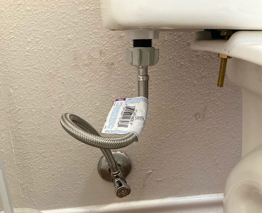 Toilet water supply line with a kinked flexible hose